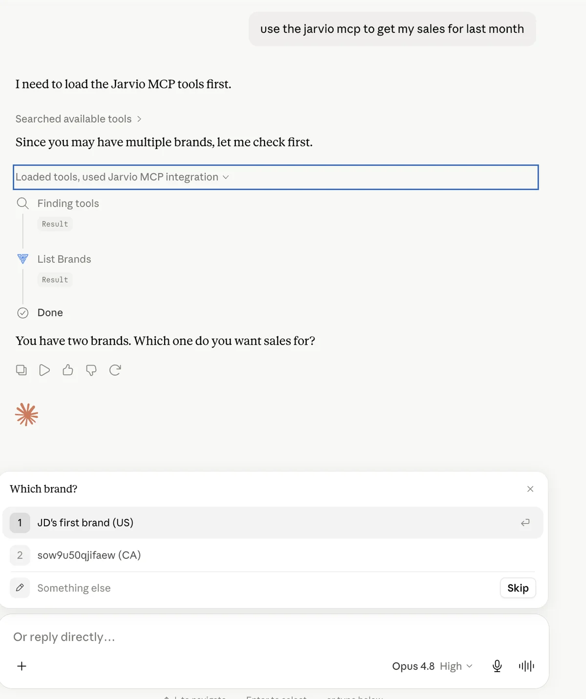 Claude.ai chat where the user asks 'use the jarvio mcp to get my sales for last month'. Claude loads the Jarvio MCP tools, calls list_brands, and presents an interactive picker asking 'Which brand?' with two options: JD's first brand (US) and a second brand (CA)